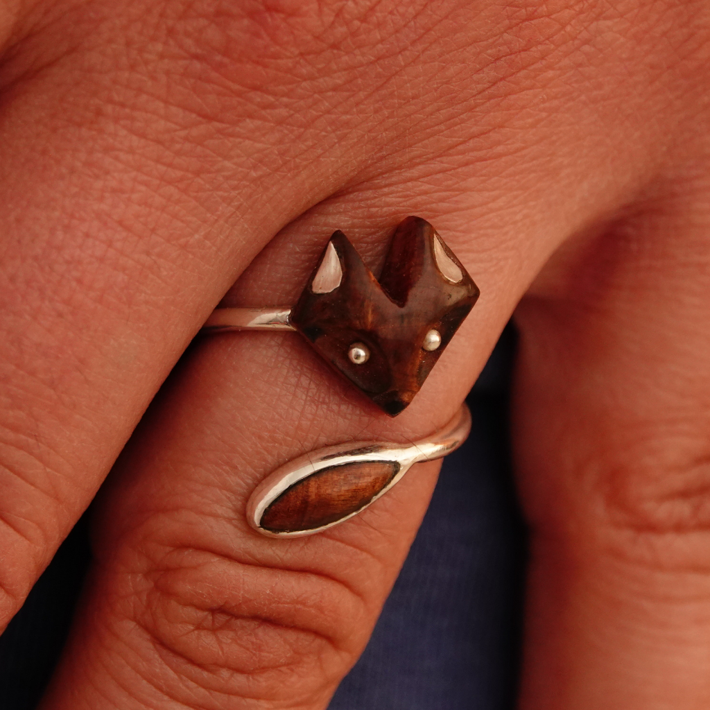 Adjustable silver ring with fox face and wooden tail.